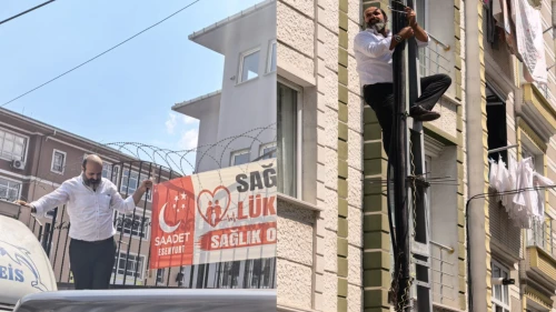Kemal Aygün’den Sultaniye’de sıra dışı eylem: Elektrik direğine tırmandı, kesilen pankartı tekrar yerine astı!